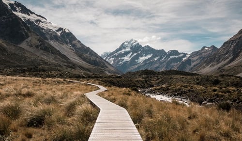 photo showing a wooden pathway with mountains in the background, much like the many decisions engineering teams need to make.